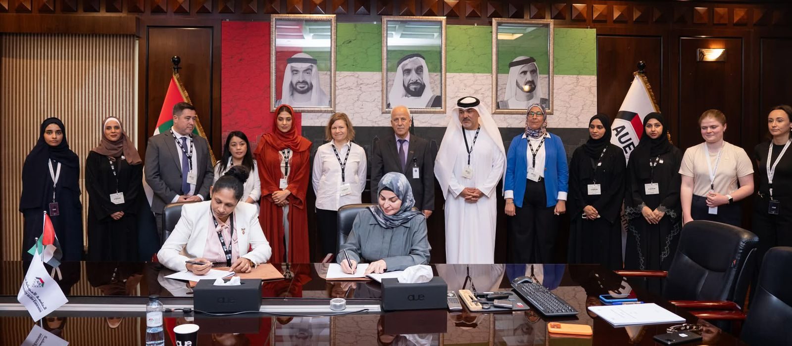 MoU signing ceremony between CMS Holoul and AUE — full boardroom view