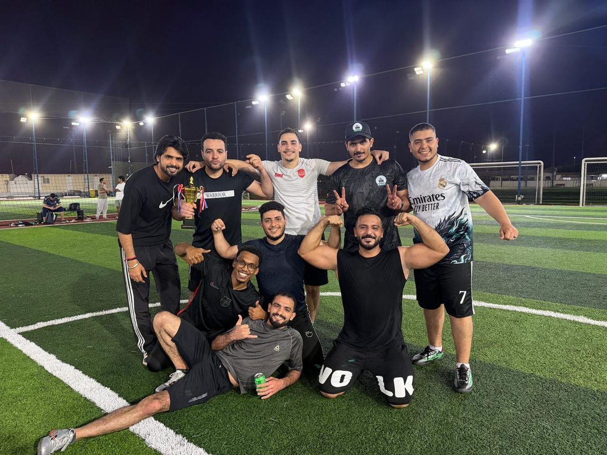 Winning team celebrating together on the pitch