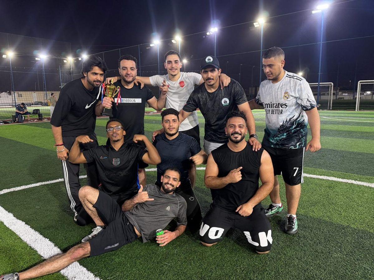 Winning team celebrating with the trophy